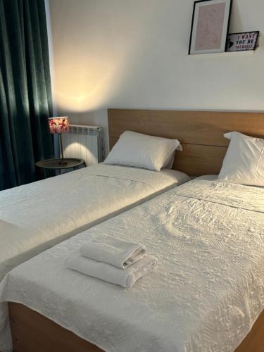 two beds in a room with towels on them at Domus kobuleti in K'obulet'i