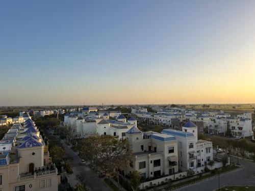 an aerial view of a city with white buildings at Hazel : Minimalist Apartment in Amritsar