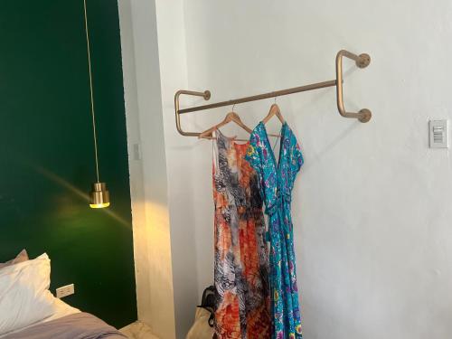 a dress hanging on a rack next to a bed at Bintana sa Paraiso Binunsaran in Mambajao