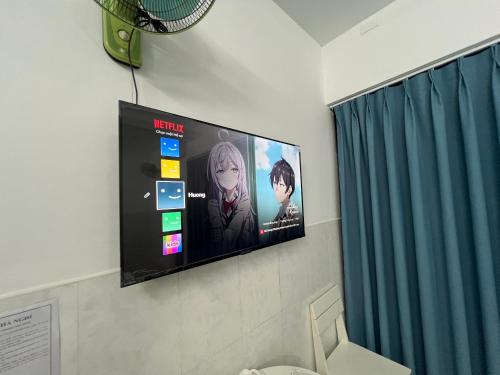 a flat screen tv hanging on a wall at Bin Hom Motel in Bien Hoa