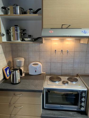 a kitchen with a stove and a counter top at Christi Apartments Α&Β in Kokkíni Khánion