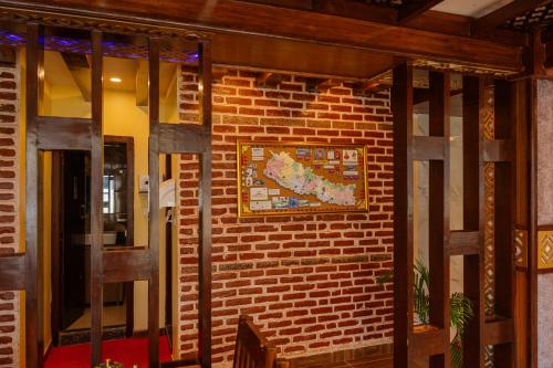 a brick wall with a picture on it at Hotel Royal Airport in Kathmandu