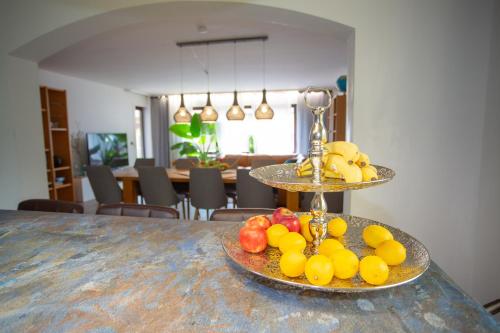 a plate of fruit on a table in a room at Villa am Wehr in Allersberg