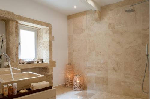 a bathroom with a sink and a shower at Le Vieux Castillon in Castillon-du-Gard