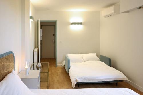 Un ou plusieurs lits dans un hébergement de l'établissement WiFi AC 5 mins from the Croisette