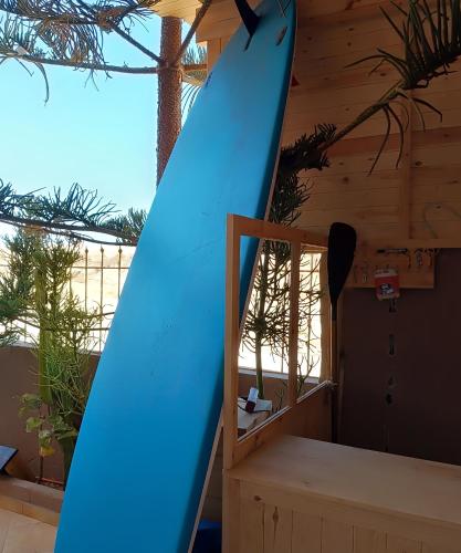 a blue surfboard sitting on top of a staircase at Tildi surf house in Imsouane