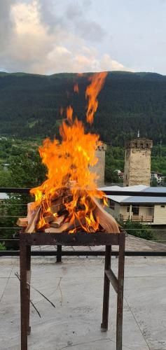 a large fire sitting on top of a bench at Mestia 4 season in Mestia