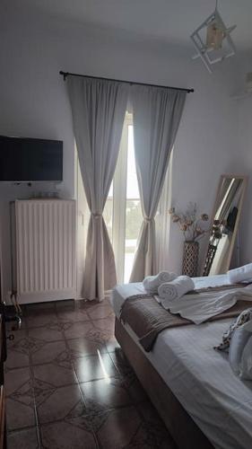 a bedroom with a bed and a large window at Althea Dream Summer House in Marmarion