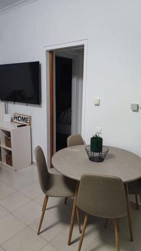 a dining room with a table and chairs and a television at Althea Dream Summer House in Marmarion