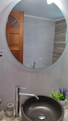 a bathroom with a sink and a mirror at Althea Dream Summer House in Marmarion