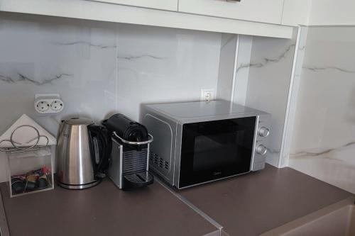a microwave sitting on a counter in a kitchen at Althea Dream Summer House in Marmarion