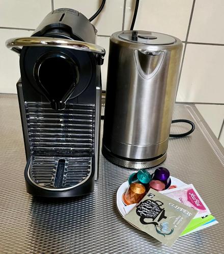 a counter with a toaster and a plate of food at B & B De Rozengracht in Doesburg