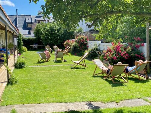 a group of people sitting in lawn chairs in a yard at Liseleje Badehotel in Liseleje