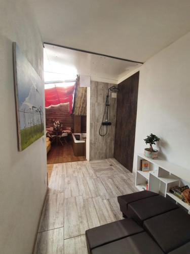a room with a bathroom with a shower and a couch at Bergamo - La Casa Di Gianna in Nembro