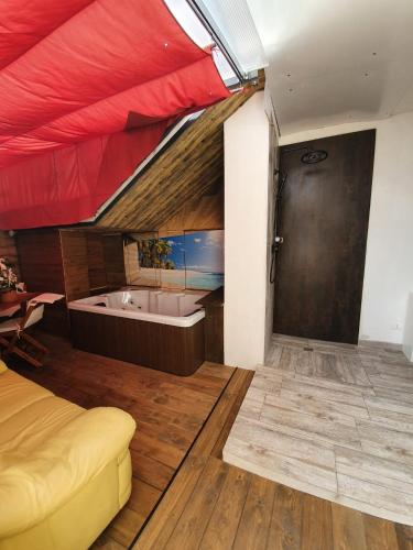 a bedroom with a bed and a tub in a room at Bergamo - La Casa Di Gianna in Nembro