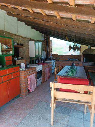 a kitchen with a table and a bench in it at Etno Kuća - Rakić in Svrljig