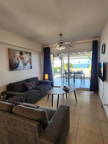 a living room with a couch and a table at Ocean Pearl in Peyia