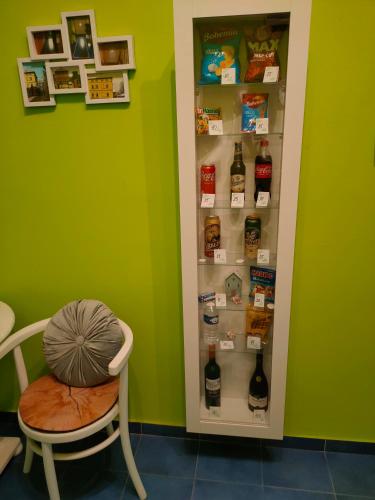 a room with a refrigerator with a chair and a pillow at Olsinky in Ústí nad Labem
