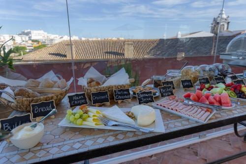 a table with different types of food on it at Casa da Moura in Lagos