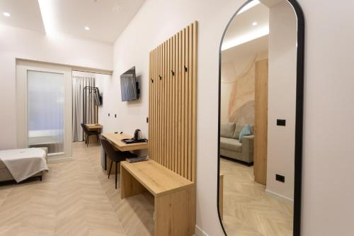 a room with a mirror and a bedroom at Nayel Hotel in Durrës