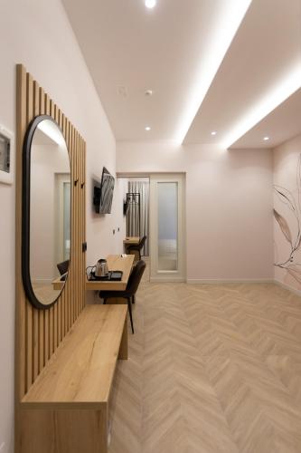 a living room with a mirror and a couch at Nayel Hotel in Durrës