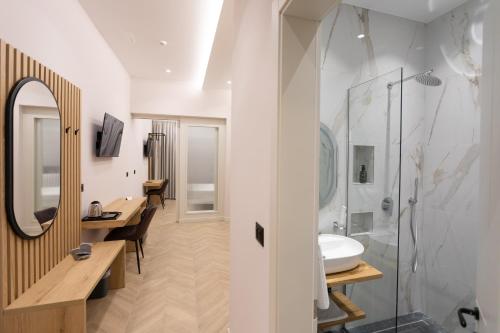 a bathroom with a sink and a mirror at Nayel Hotel in Durrës