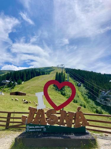 a sign in the shape of a heart on a hill at Apartment Jasná Otupné in Demanovska Dolina