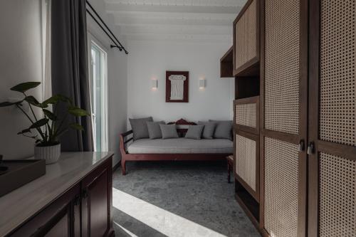 a living room with a couch and a table at Pelican Bay Hotel in Platis Yialos Mykonos