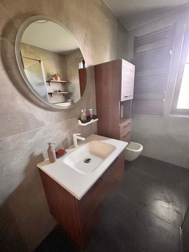 a bathroom with a sink and a mirror at SECOND HOME Banovci in Veržej