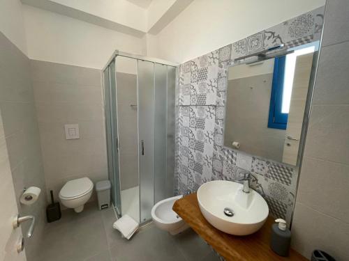 a bathroom with a sink and a toilet and a shower at Bed and Breakfast Da Francesca in Castelluzzo