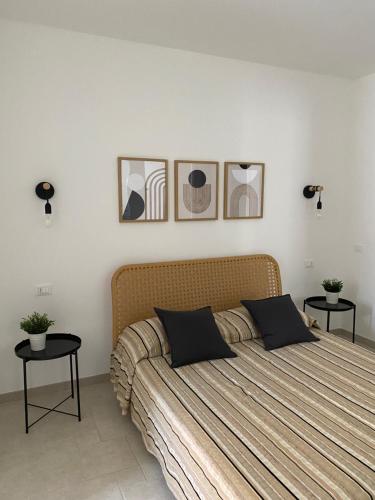 a bedroom with a large bed with two tables at Villa Serena in Monopoli
