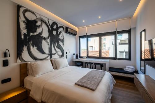 a bedroom with a large bed with a large painting on the wall at Athensis Acropolis View next to Ermou street! in Athens