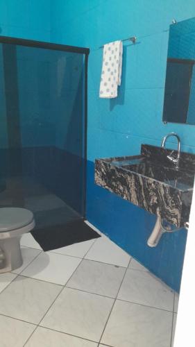 a bathroom with a sink and a toilet at Blue House in Lençóis