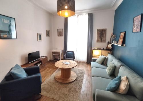 a living room with a couch and a table at CŒUR MENOU, Radis'son & PARKING in Nantes