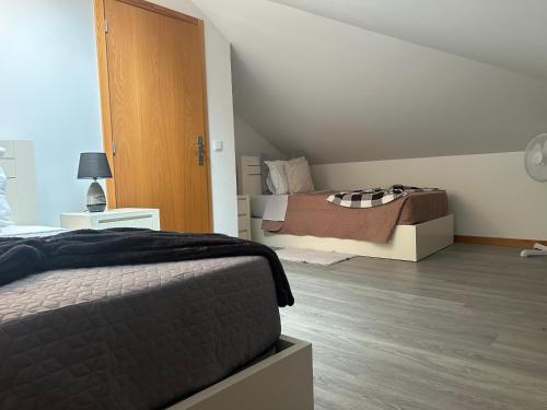 a bedroom with a bed and a room with a bed sqor at House of the sun in Ponta do Sol