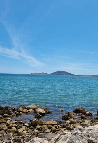a large body of water with rocks in the foreground at Gliù Vico in Formia