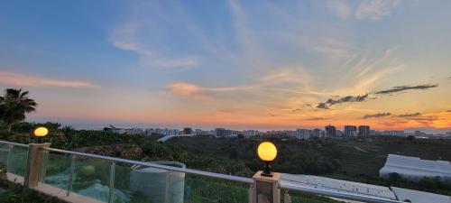 a view of a city from a balcony with two lights at Jasminpark Villa in Alanya
