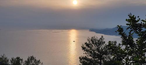 a view of a lake with the sun shining on the water at Jasminpark Villa in Alanya
