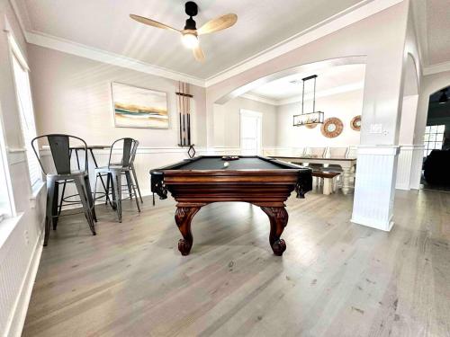 a room with a pool table and a dining room at Coastal91 Free Golf Cart Gated Beach Access in Destin