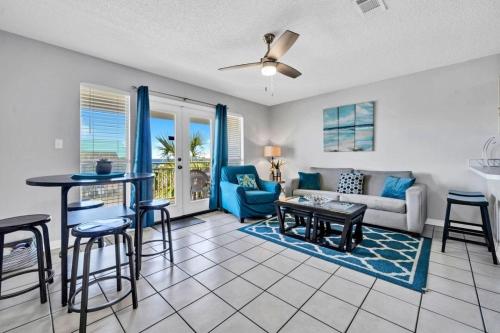 a living room with a couch and a table at Caribleu Getaway Beach View Hot tub & Pool in Destin