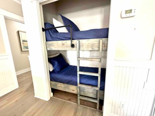 a couple of bunk beds in a room at Coastal91 Free Golf Cart Gated Beach Access in Destin