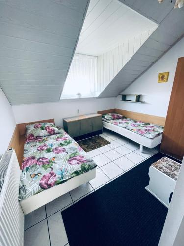 a room with two beds in a attic at Noclegi u Zygmunta in Mielno