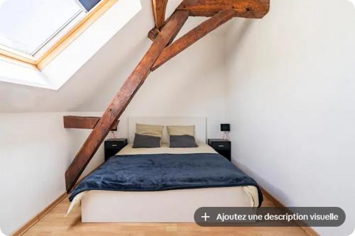 a bedroom with a bed in a attic at Gîte du Coudray in Neuillé-Pont-Pierre