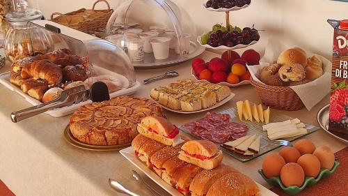 a table with many different types of bread and pastries at B&B Vista Mare in San Vito lo Capo