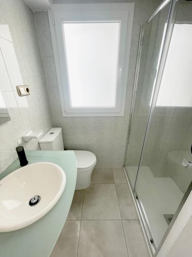 a bathroom with a toilet and a sink and a shower at AT Paseo Ficus Centenario in Almería