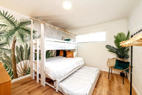 a bedroom with a bunk bed and a palm tree mural at Eden Escape Lake View 3 Pools Pet Friendly in Destin