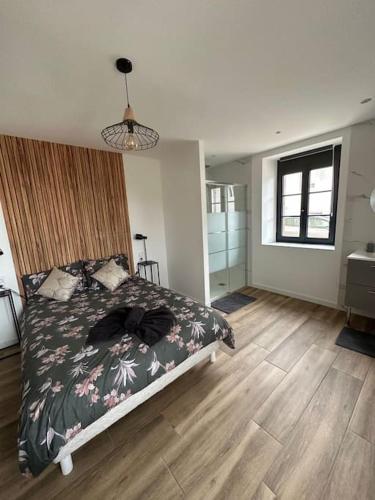 une chambre avec un lit et un parquet dans l'établissement Le petit jurassien 2, à Bellefontaine