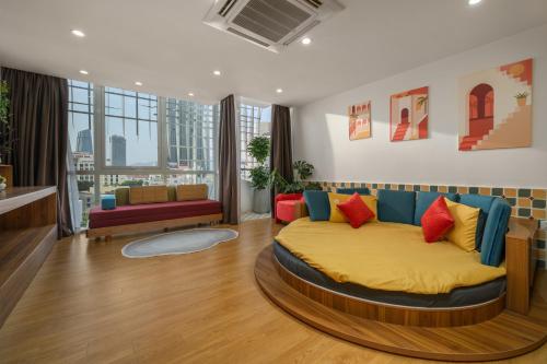 a bedroom with a large bed with colorful pillows at Q Apartment Da Nang in Da Nang