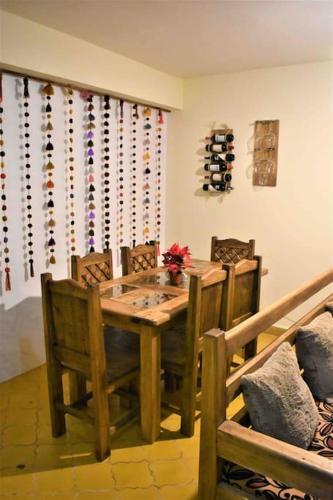 a dining room with a wooden table and chairs at La casita, ubicada en el centro in San Cristóbal de Las Casas