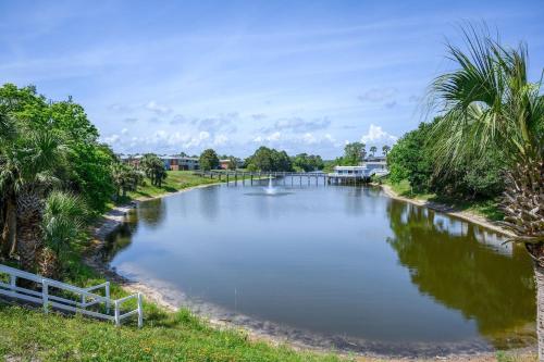 a river with a bridge in the middle at Tranquil Tortuga Lake View Central Destin in Destin